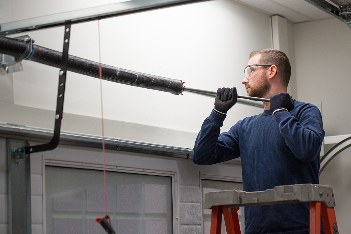 A technician repairing a garage door